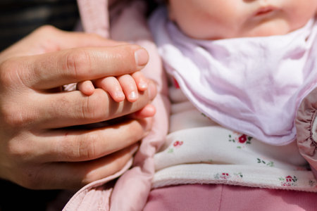 The little palm of the newborn daughter on the hand of the father. Up closeの写真素材