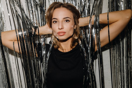 Portrait of a European girl on the background of a gray curtain