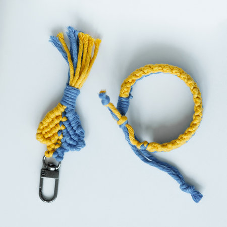 A vibrant, handcrafted macrame keychain and bracelet set, featuring a beautiful interplay of blue...