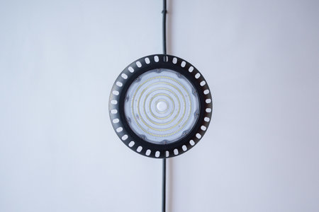 Innovative circular LED light fixture suspended against a minimalist background