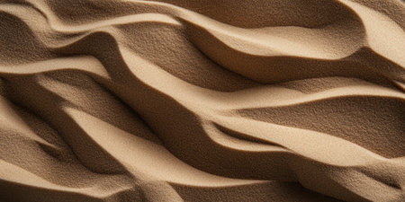 Delicate grains of sand glisten in soft sunlight, creating mesmerizing patterns that dance across the surface. Each wave captures a moment of natural beauty, inviting calm and reflection.の素材