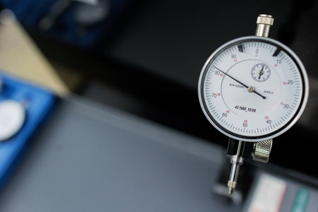 Precision Measuring Tool Showcasing Meticulous Engineering in a Workshop Setting Under Bright Lightingの写真素材