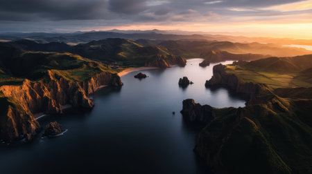 Soft light of dawn paints the steep coastline in warm hues, revealing dramatic cliffs and calm waters. A serene beginning to a beautiful day unfolds in nature's masterpiece.の素材