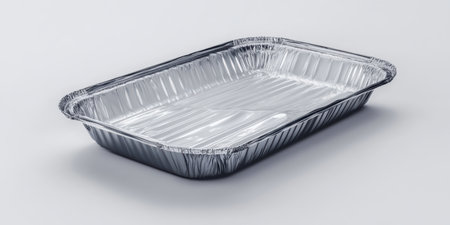 Unused, wrapped disposable BBQ grill showcased in a clean, simple mockup style, perfect for outdoor cooking, picnics, and summer barbecues, ready for immediate use in various locations.の素材