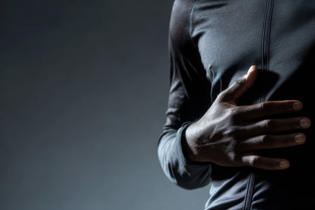 A hand gently rests on the stomach, illustrating the deep breath motion, with a subtle play of muscle tone against a clean, light backdrop. The atmosphere evokes tranquility and focus.の素材