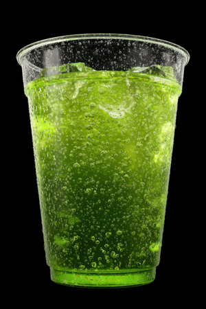Refreshing cold green apple soda served in a frosty tumbler, capturing the essence of summer refreshment on a sunny dayの素材