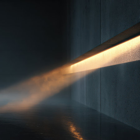 Soft light from a recessed smart fixture shines on a textured wall, revealing floating dust particles in the air.の素材