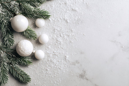 Snow-covered pine branches hold glimmering white ornaments, creating a cozy winter scene perfect for festive celebrations.の素材