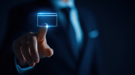 A person in a suit gently touches a glowing digital card, showcasing a blend of technology and business in a modern setting.の素材