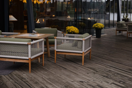 A tranquil outdoor space features stylish seating made of wood and wicker, complementing the vibrant...