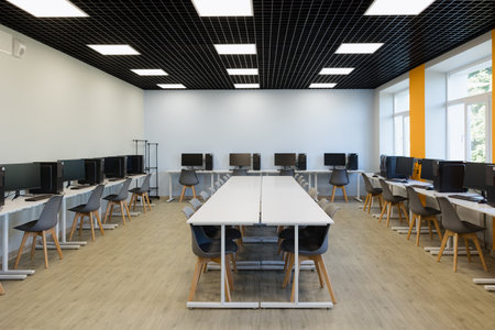 Bright and airy workspace featuring multiple computer stations, stylish furniture, and ample natural...
