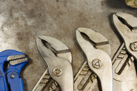 Various tools arranged on a metallic surface captured in a creative workspace