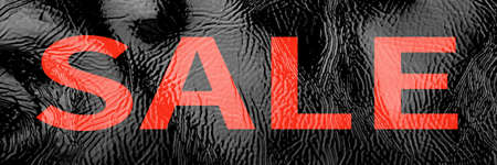 Black banner background patent leather texture close up, inscription SALE in large red letters. Black Friday pre-holiday shop and sale concept. Flyer shopping, online sale. Screensaver for the site.の写真素材
