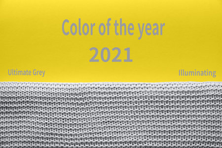 A beautiful gray knitted plaid on yellow background illuminating. Perfect background color year...