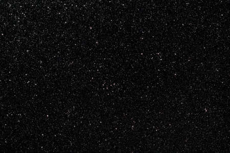 Black glitter texture sparkling festive glowing shiny wrapping paper background for Christmas and New Year party, copy-space holiday wallpaper decoration, greeting and Black Friday invitation card.の写真素材