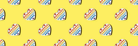 Seamless pattern diagonal of yellow color in the form of a banner with teaching the English alphabet abc, a popular toy simple dimple with multi-colored. Layout concept for cover or wrapping paper.の写真素材