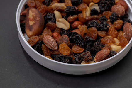 Mix of nuts with dried fruits, peanuts, Brazil nuts, cashew nuts, almonds, black raisins and white...