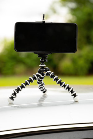 Articulating mini tripod for photography holding a smartphoneの写真素材