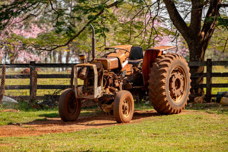 Dirty little simple tractor on a farmの写真素材