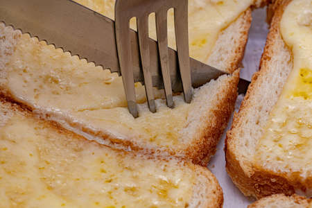 Loaf of bread with slice of melted mozzarella cheese on topの写真素材