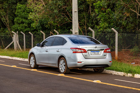 Costa Rica, Mato Grosso do Sul, Brazil - 12 18 2022: Silver sedan car of the nissan sentra model with New license plate standard implemented in thのeditorial素材