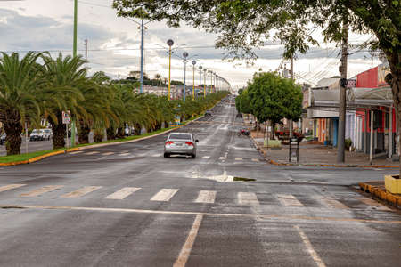 Costa Rica, Mato Grosso do Sul, Brazil - 12 18 2022: Duplicate avenue with wet asphalt after rainのeditorial素材