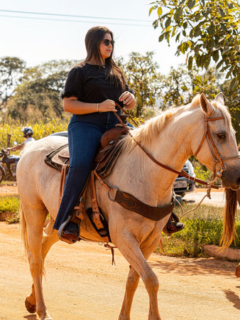 Apore, Goias, Brazil - 05 07 2023: Horseback riding event open to the public on public roads in the Brazilian city of Aporeのeditorial素材