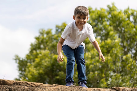boy in blue jeans and white t-shirt having fun outdoorsの写真素材
