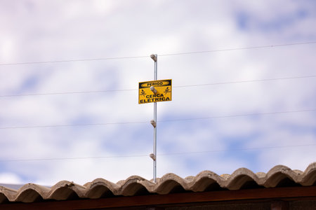 closeup of electric fence with electric fence danger signの写真素材