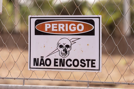 Itaja, Goias, Brazil - 06 17 2023: danger warning sign do not touch a gate of an electrical substationのeditorial素材