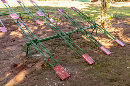 green and red metal seesaw in park playground