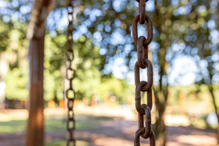 swing steel chain suspended in playground selective focusの写真素材