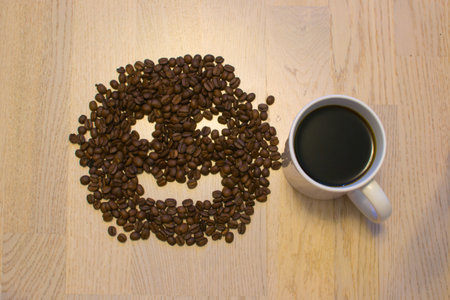A cup of coffe with coffee bean as backgroundの写真素材