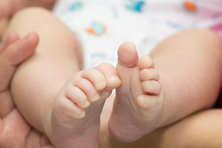 little baby feet and smiling on white
