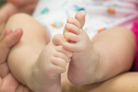 little baby feet and smiling on white