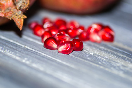 garnet closeup on wooden background juicy redの写真素材