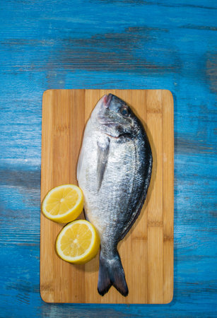 fish delicacy on wooden background with lemon