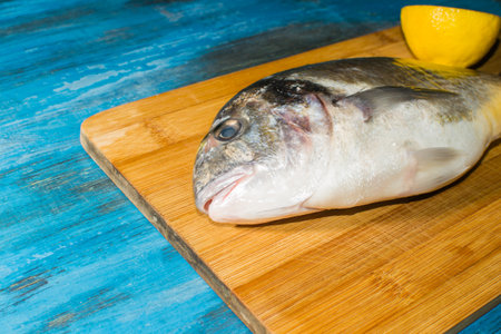 fish delicacy on wooden background with lemon