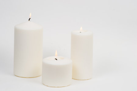 a candle is lit in the darkness and gives spiritual warmthの写真素材