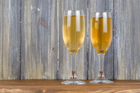 a glass of champagne on a wooden background holidayの写真素材