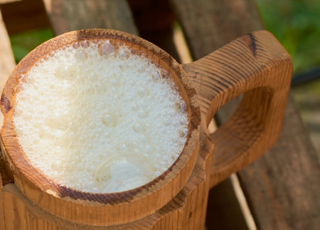 beer in a wooden mug on a background of ripe juicy summerの写真素材