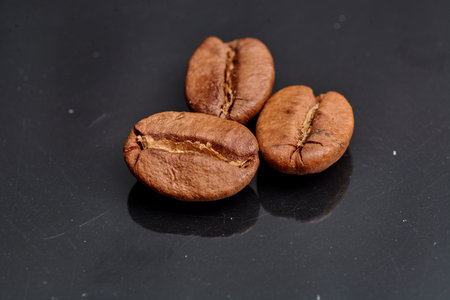 coffee beans on black background consistent with the view in the macroの写真素材