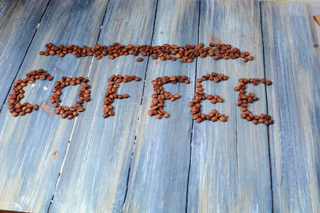 coffee bean lettering close-up top view on white backgroundの写真素材