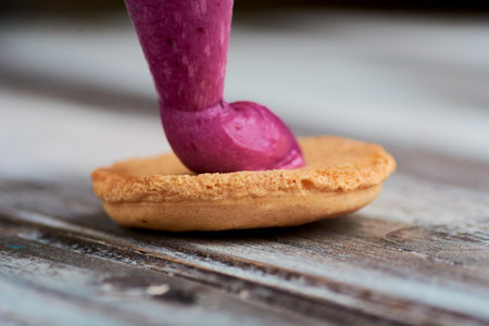 cooking homemade macarons at home with your hands on a white backgroundの写真素材
