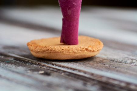 cooking homemade macarons at home with your hands on a white backgroundの写真素材