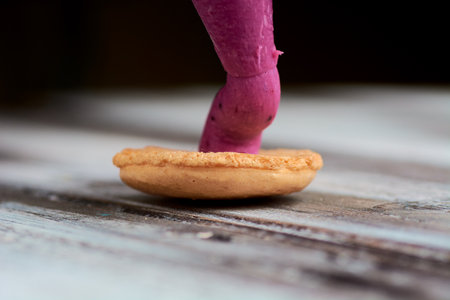 cooking homemade macarons at home with your hands on a white backgroundの写真素材