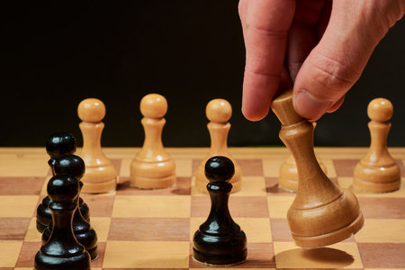 hand of businessman moving chess figure in competition success play. strategy, management or leadership conceptの写真素材