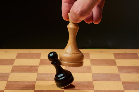 hand of businessman moving chess figure in competition success play. strategyの写真素材