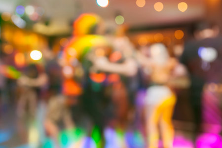 Defocused scene in the night club with bokeh lights and people silhouettesの写真素材