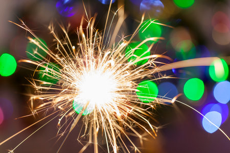 Christmas sparkler with bokeh lights on the backgroundの写真素材